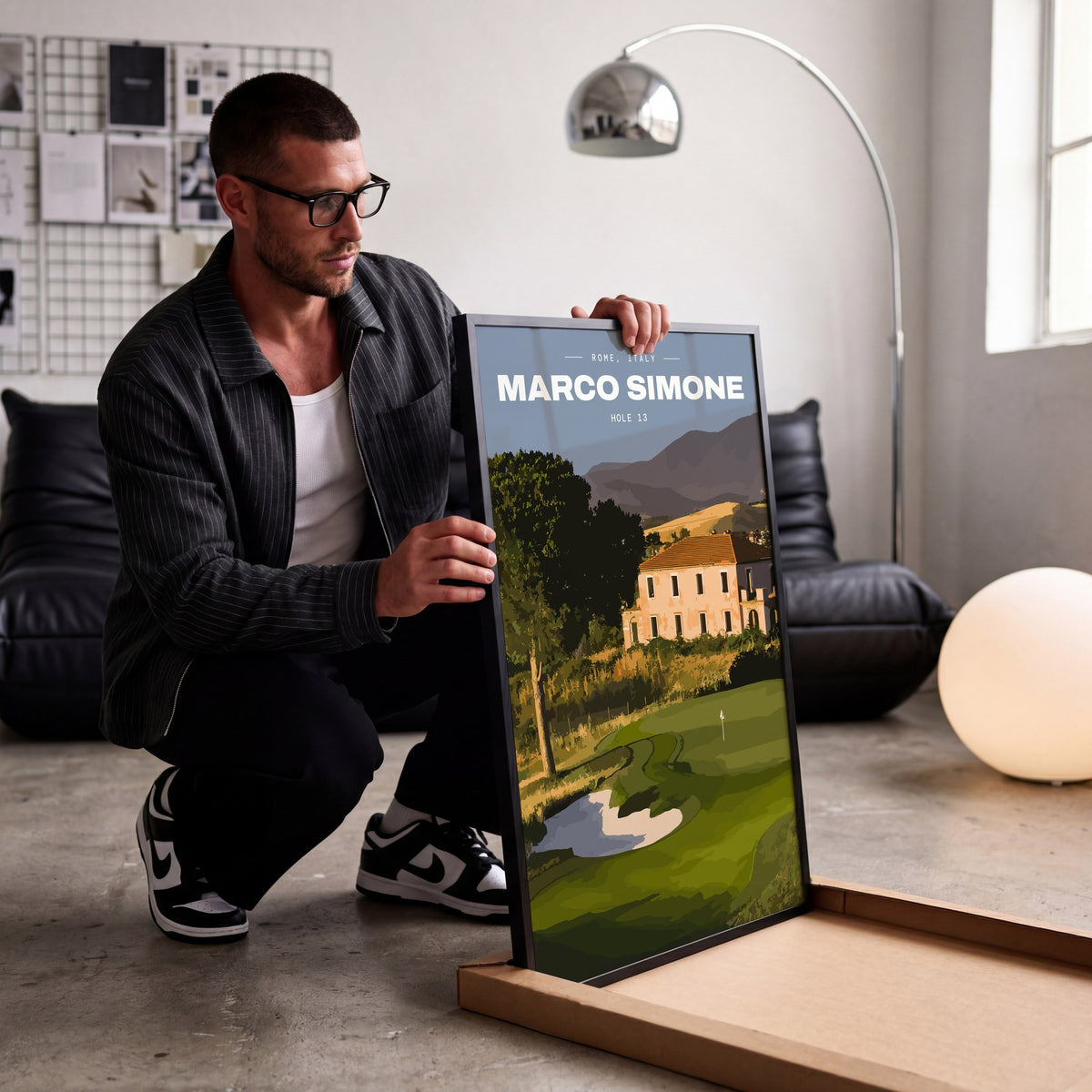 Marco Simone 13th hole golf print of a green below an old villa and hills, being unboxed in a bright studio
