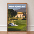 Marco Simone 13th hole golf print of a green below an old villa and hills, in an oak frame, leaning against a wall on a herringbone floor