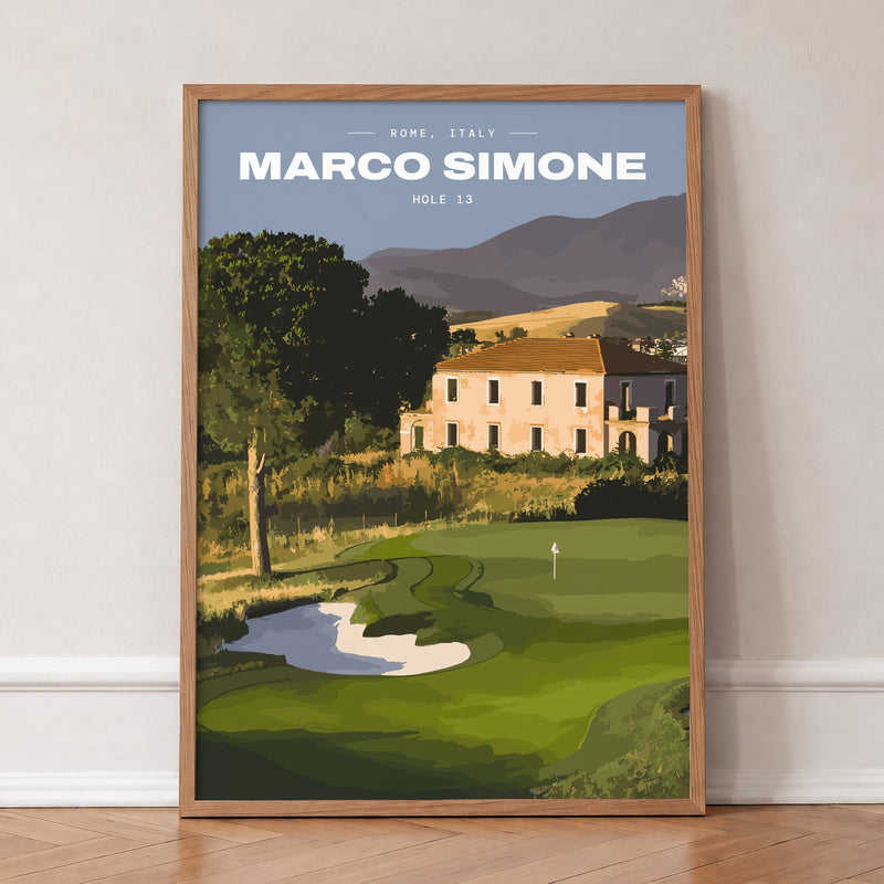 Marco Simone 13th hole golf print of a green below an old villa and hills, in an oak frame, leaning against a wall on a herringbone floor