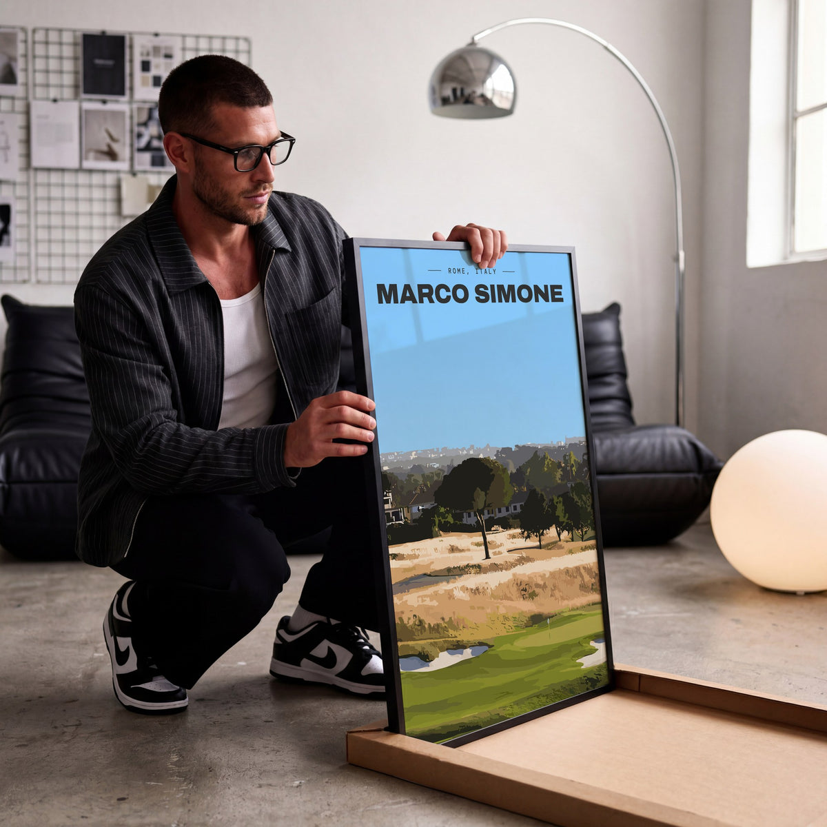 Marco Simone golf print of a green below umbrella pines and gold rough, being unboxed in a bright studio