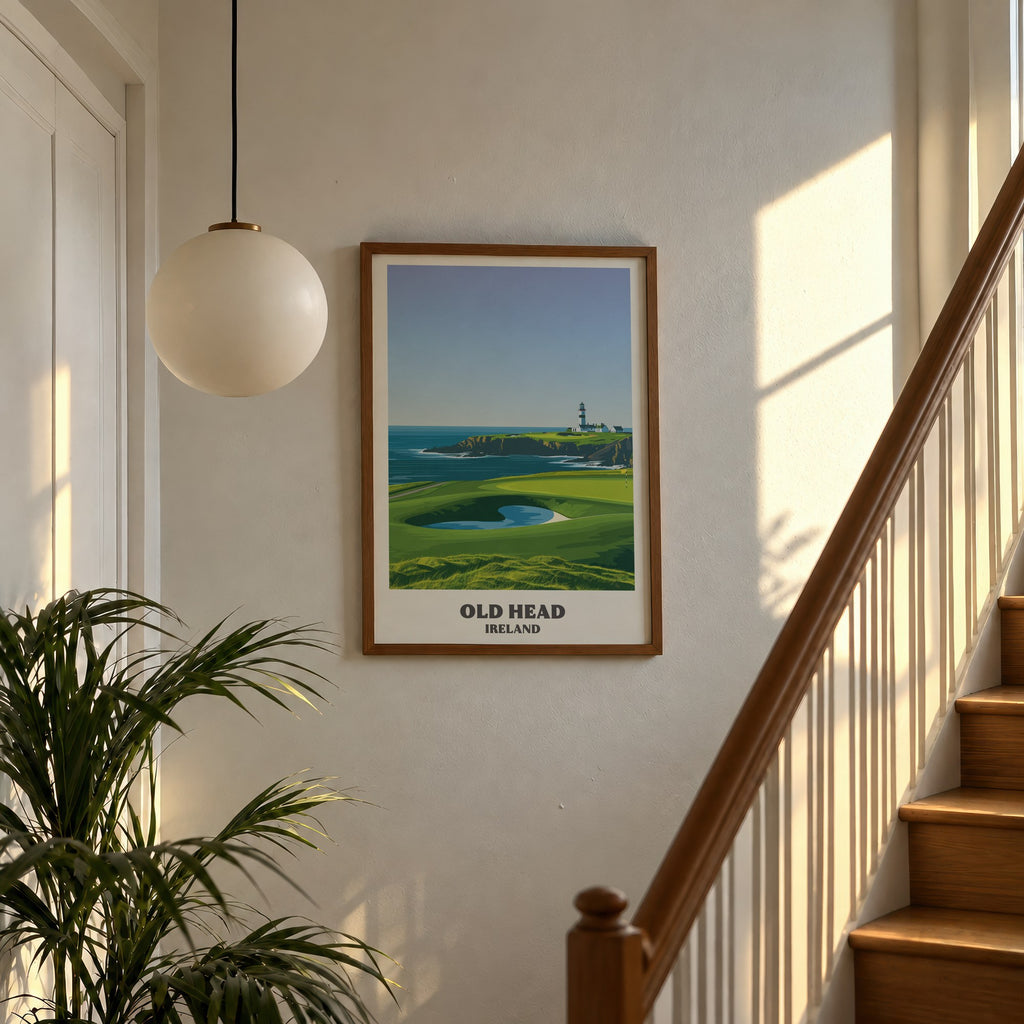 Old Head golf print of a lighthouse on a headland above a green, framed above a sunlit staircase