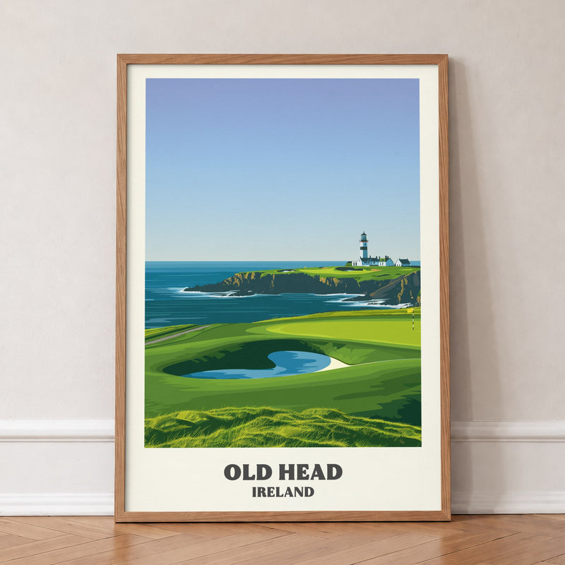 Old Head golf print of a lighthouse on a headland above a green, in an oak frame, leaning against a wall on a herringbone floor