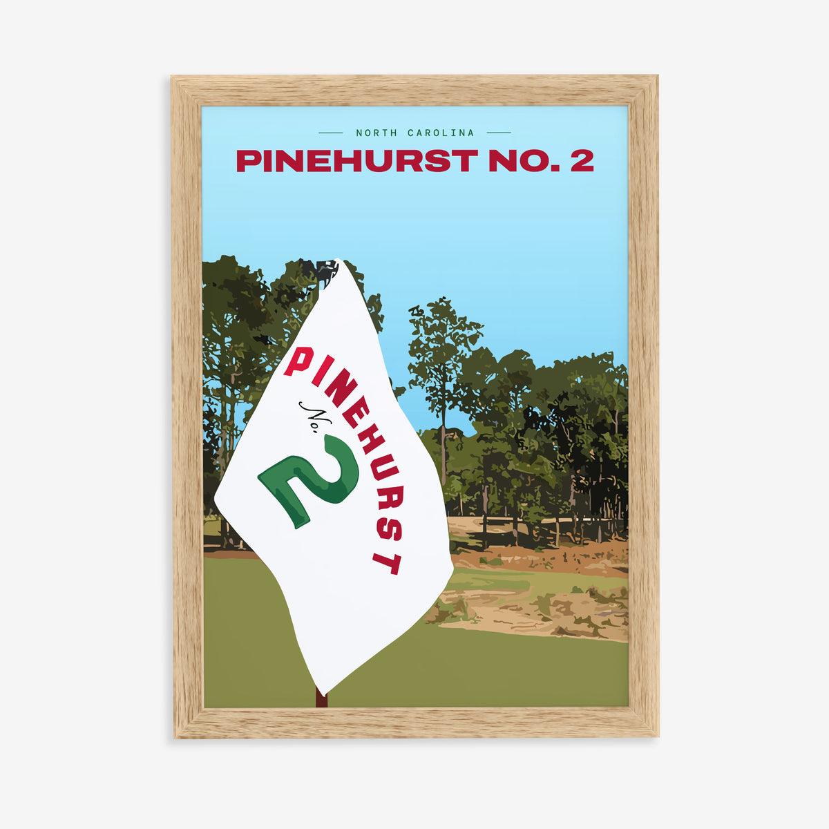 Pinehurst No. 2 golf print of a white pin flag before sandy waste and pines, in a natural wood frame on a plain wall