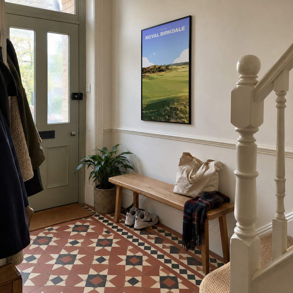 Royal Birkdale golf print of a links fairway and red flag between dunes, framed in a hallway with patterned floor tiles