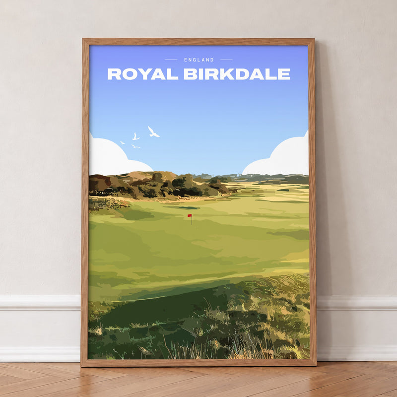 Royal Birkdale golf print of a links fairway and red flag between dunes, in an oak frame, leaning against a wall on a herringbone floor