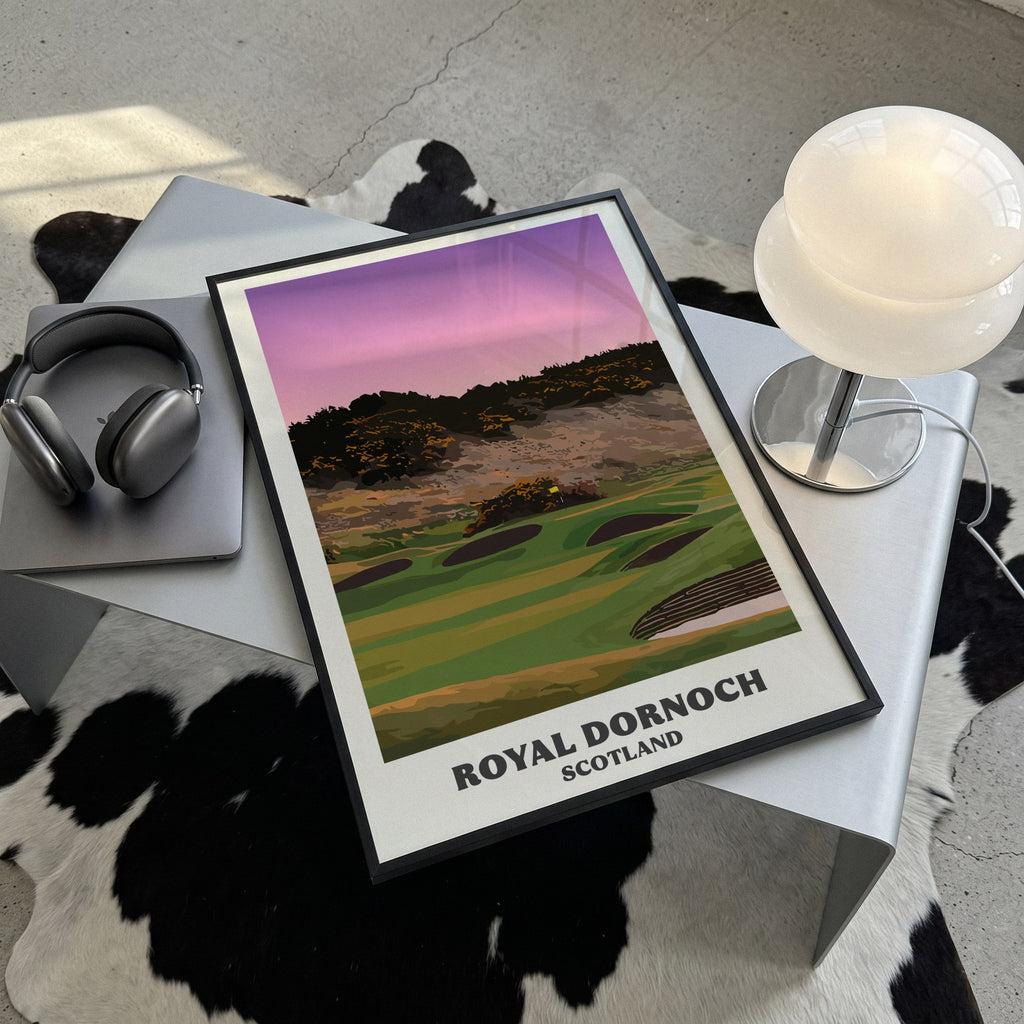 Royal Dornoch golf print of a plateau green below a gorse hill at dusk, framed, lying on a steel table on a cowhide rug