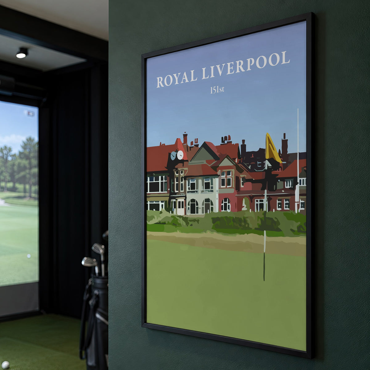 Royal Liverpool 2023 golf print of the clubhouse behind a yellow flag, framed on a green wall beside a golf simulator