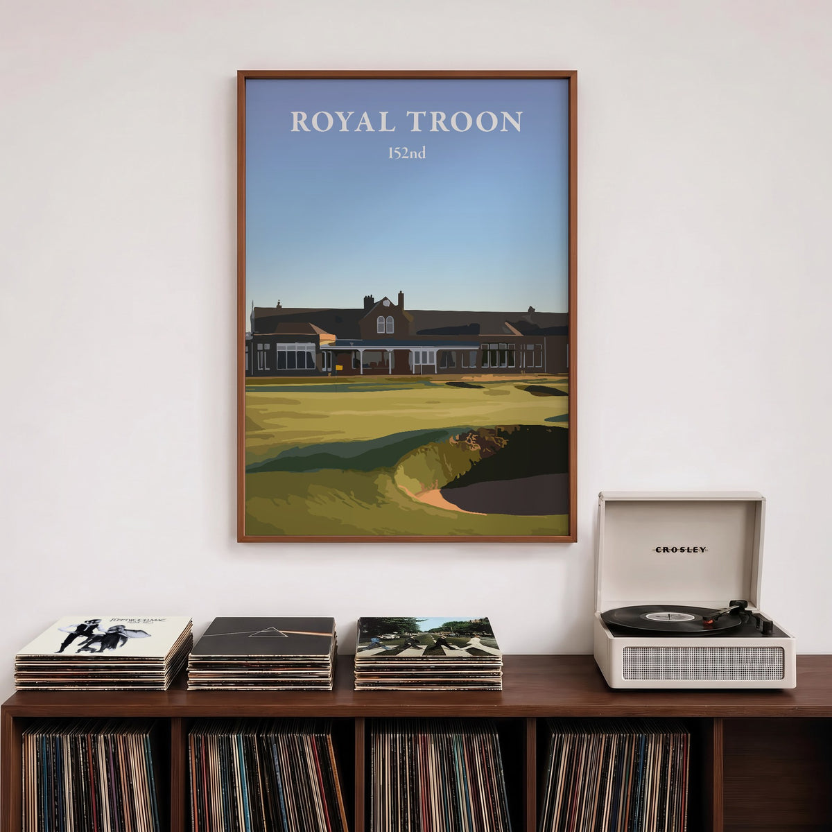 Royal Troon 2024 golf print of the clubhouse behind the 18th green, framed above a record shelf beside a turntable