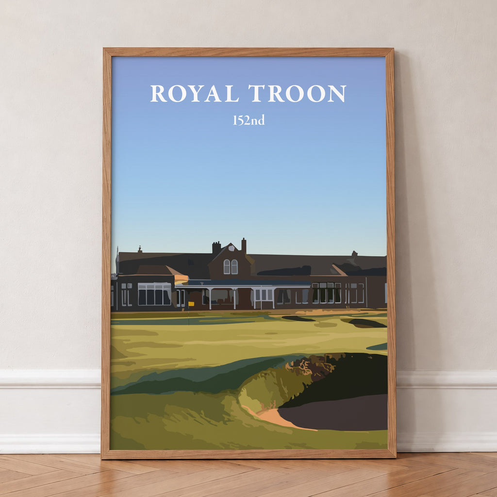 Royal Troon 2024 golf print of the clubhouse behind the 18th green, in an oak frame, leaning against a wall on a herringbone floor