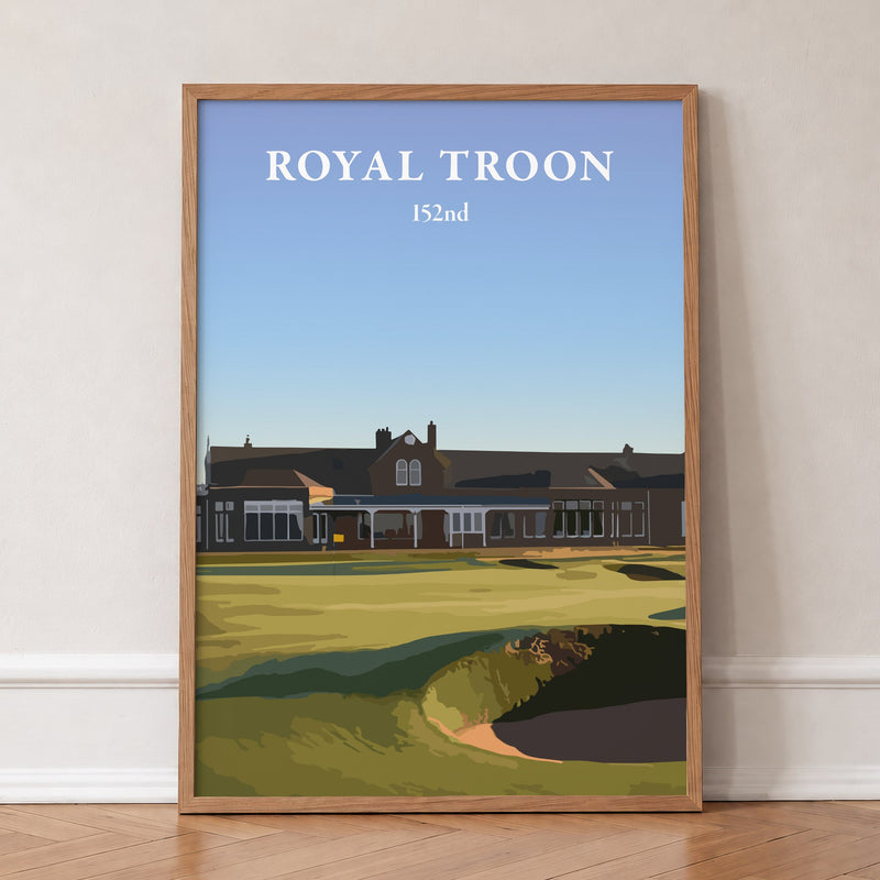 Royal Troon 2024 golf print of the clubhouse behind the 18th green, in an oak frame, leaning against a wall on a herringbone floor