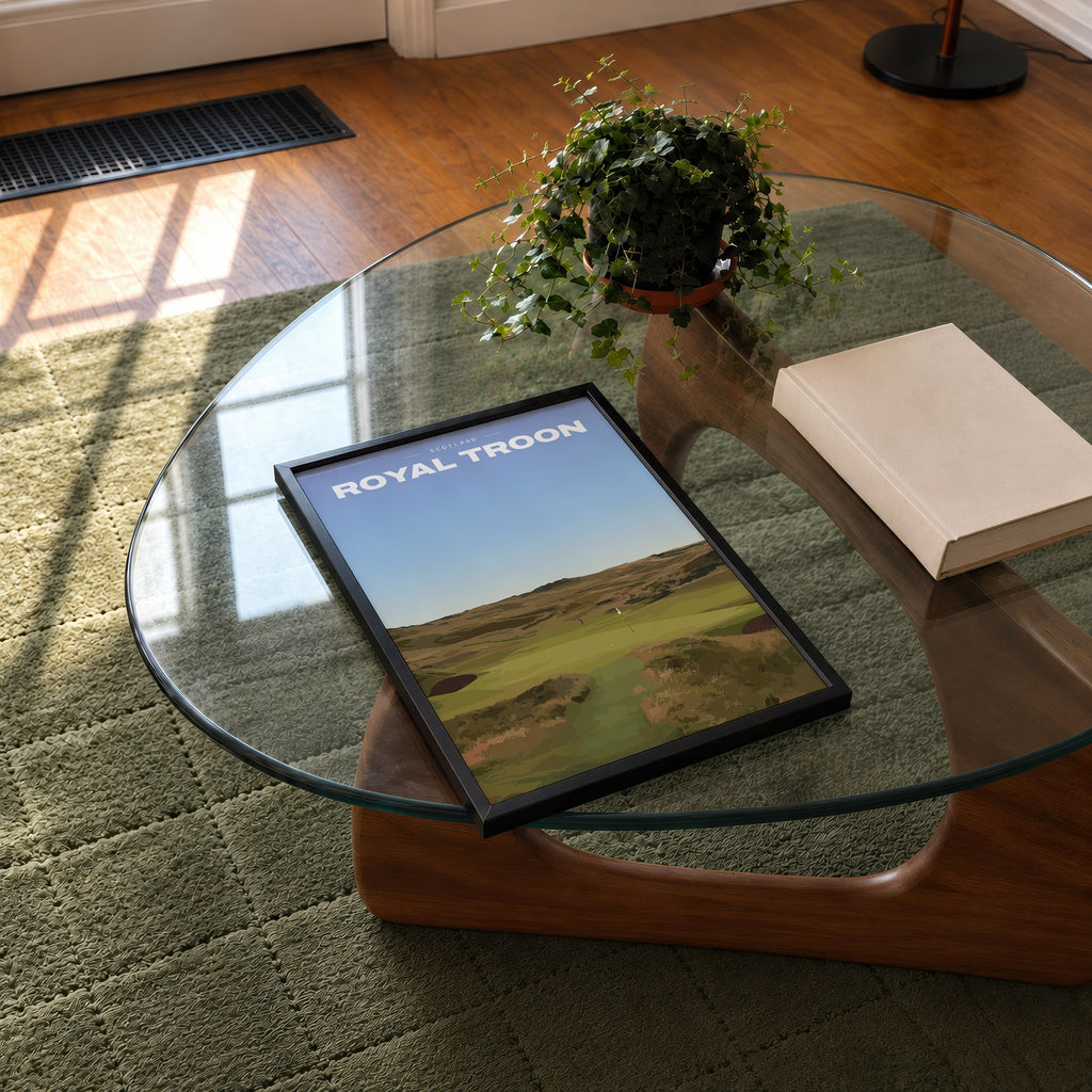 Royal Troon golf print of a links fairway through dunes to a flag, framed on a glass coffee table