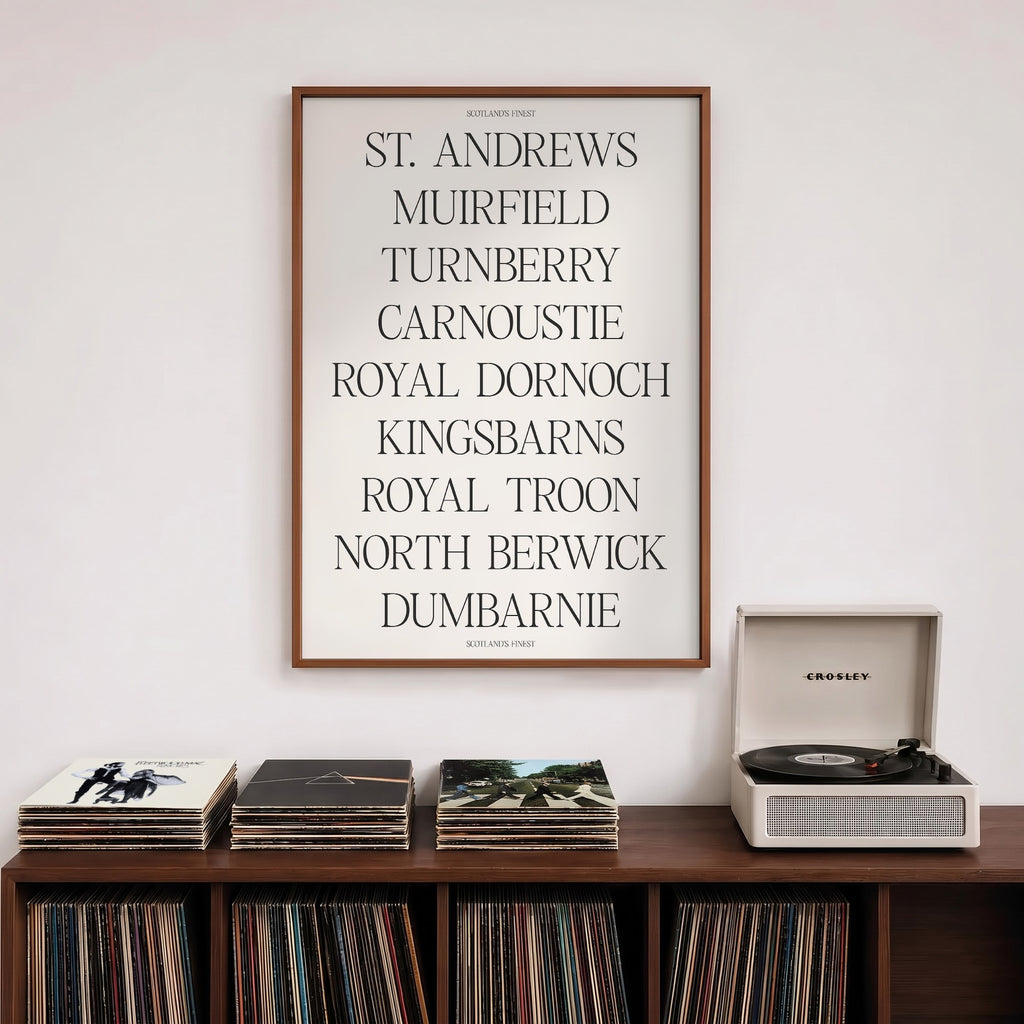 Scotland's Finest golf print of nine Scottish course names in serif type, framed above a record shelf beside a turntable