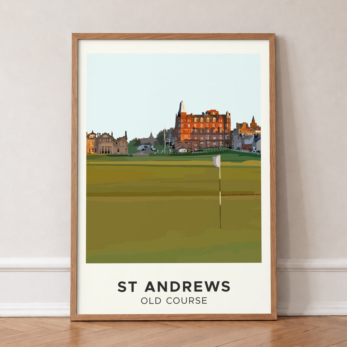 St Andrews Old Course golf print of the 18th green below Hamilton Grand, in an oak frame, leaning against a wall on a herringbone floor
