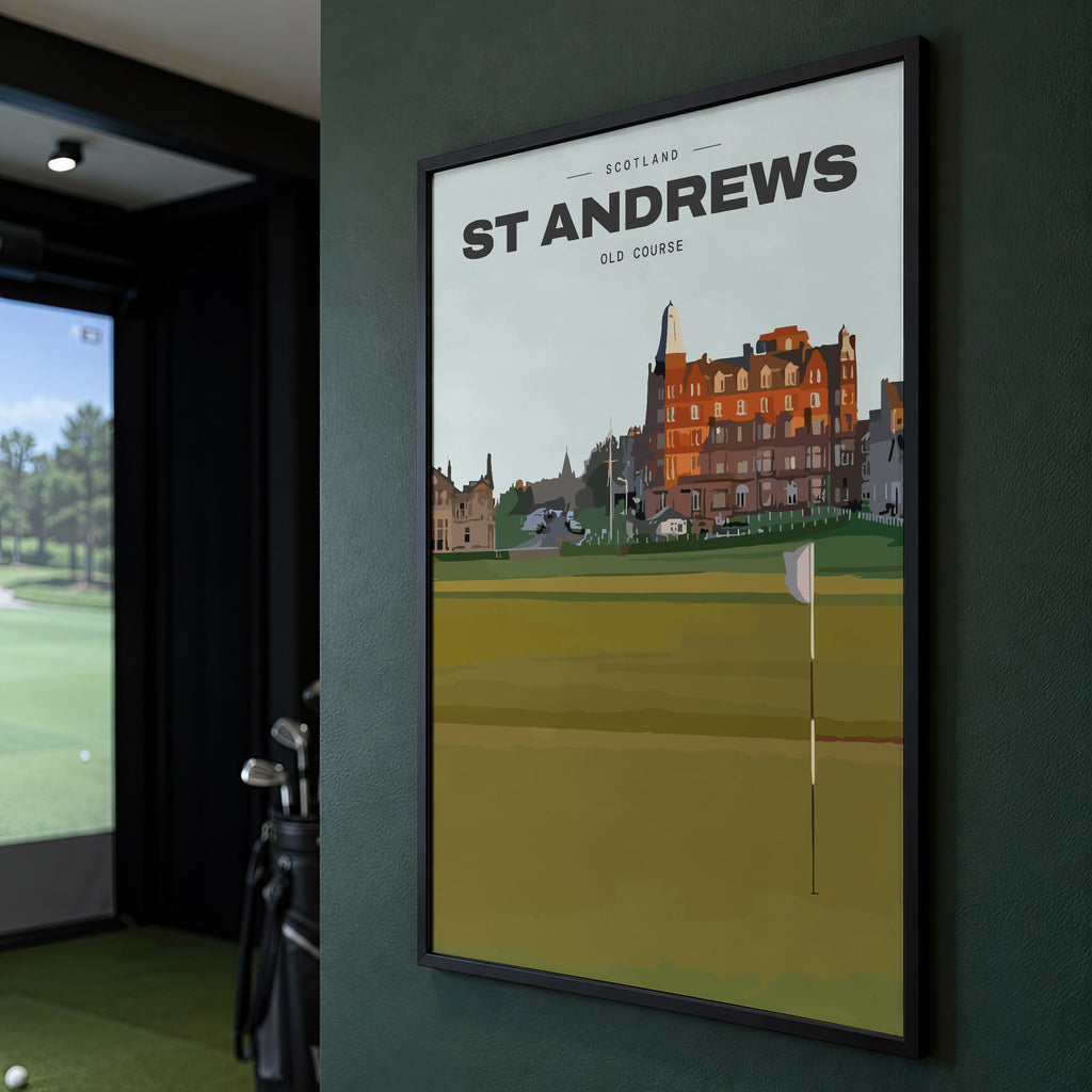 St Andrews Old Course golf print of the 18th green and flag below the town, framed on a green wall beside a golf simulator