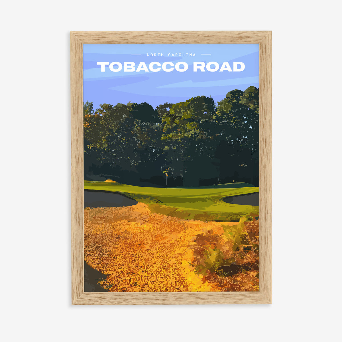 Tobacco Road golf print of a green behind golden sand and pines, in a natural wood frame on a plain wall
